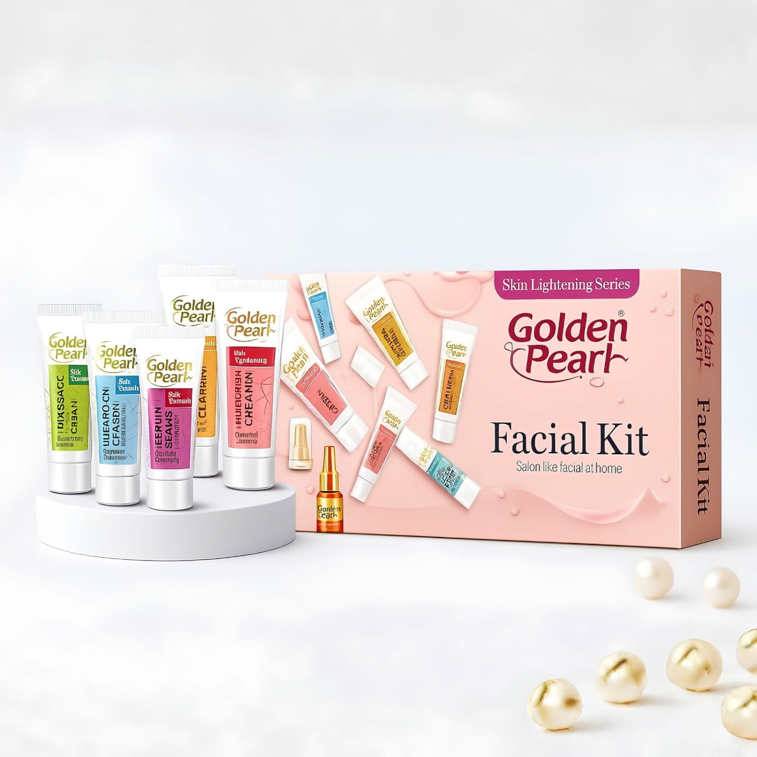 Golden Pearl Facial Kit with its pink box and five colorful treatment tubes arranged on a white pedestal, with decorative gold pearls on a clean white background.