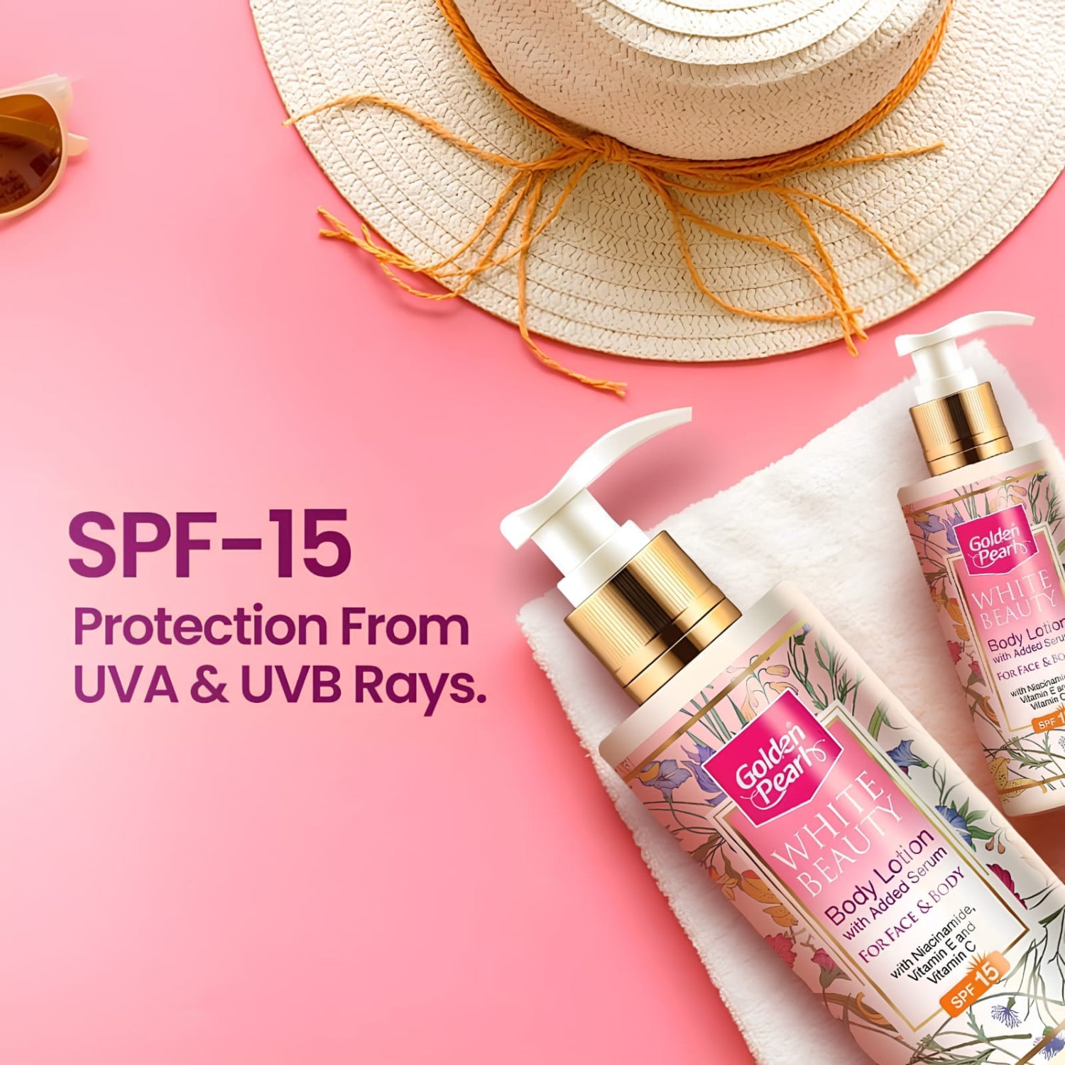 Two Golden Pearls White Marble SPF 15 Body Lotion bottles arranged on a white towel against a pink background, with a straw hat and partial sunglasses as props. Text on the left reads 'SPF-15 Protection From UVA & UVB Rays.