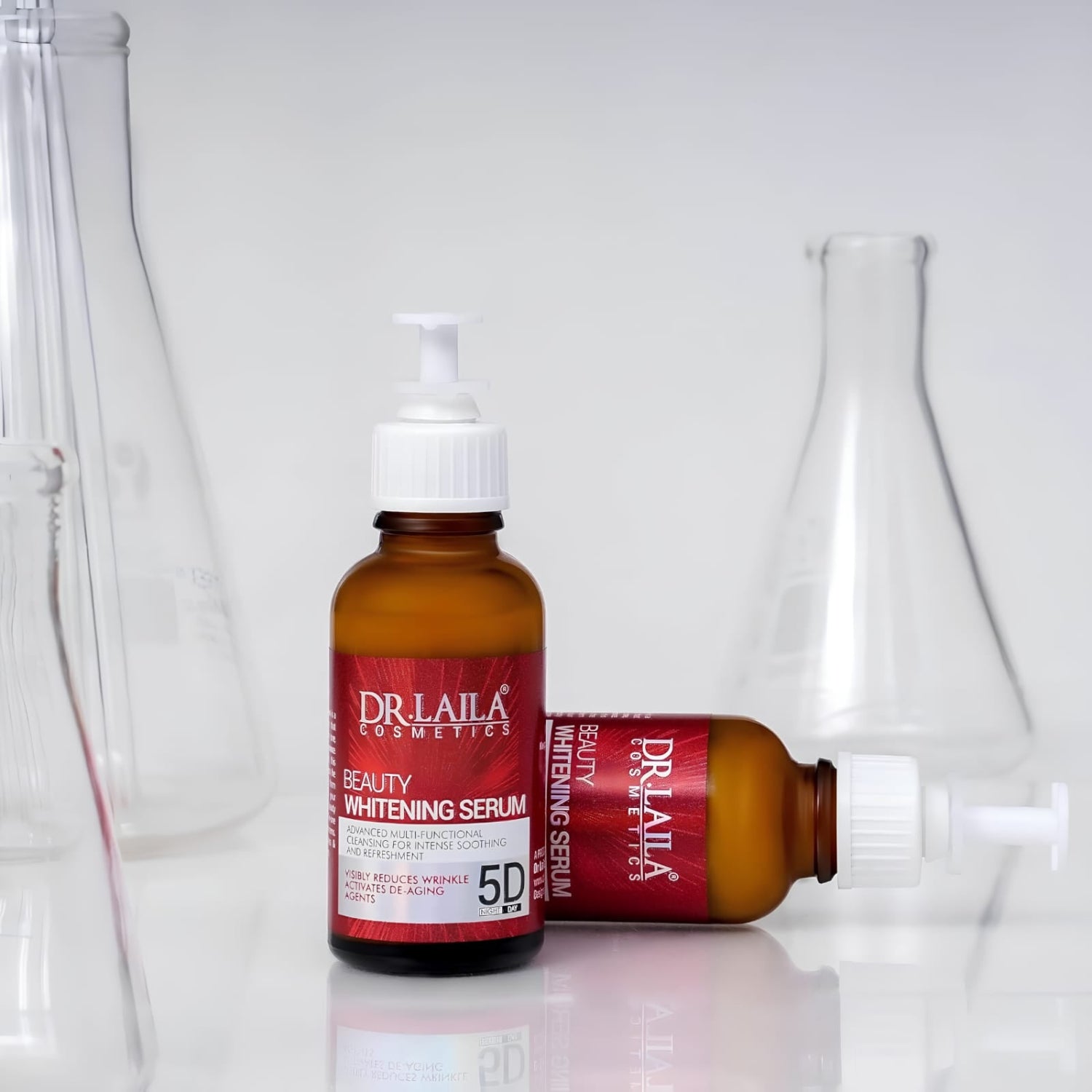 Dr. Laila Cosmetics Beauty Whitening Serum in an amber glass bottle with a white pump dispenser, shown alongside another bottle lying on its side, set against a white background with blurred glass flask props.