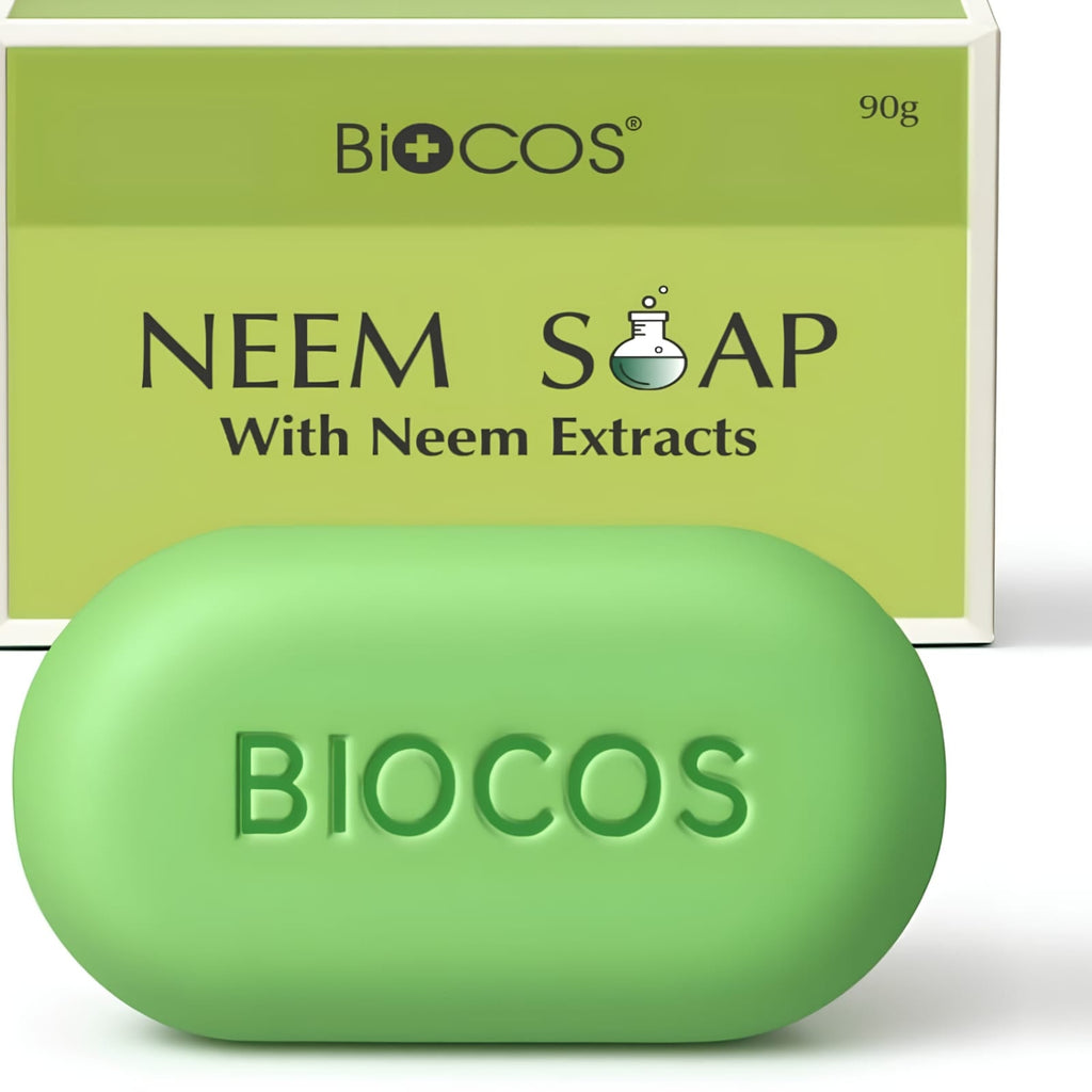 A green oval bar of BIOCOS Neem Soap with Neem Extracts in the foreground, with its matching light green cardboard packaging box behind it on a white background.