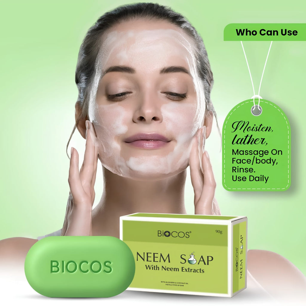 A woman with a white face mask applies massage motions to her face, with a green BIOCOS Neem Soap bar and matching product box in front. Text callouts on a light green background describe use and scent, with the BIOCOS brand visible on both the soap and packaging.