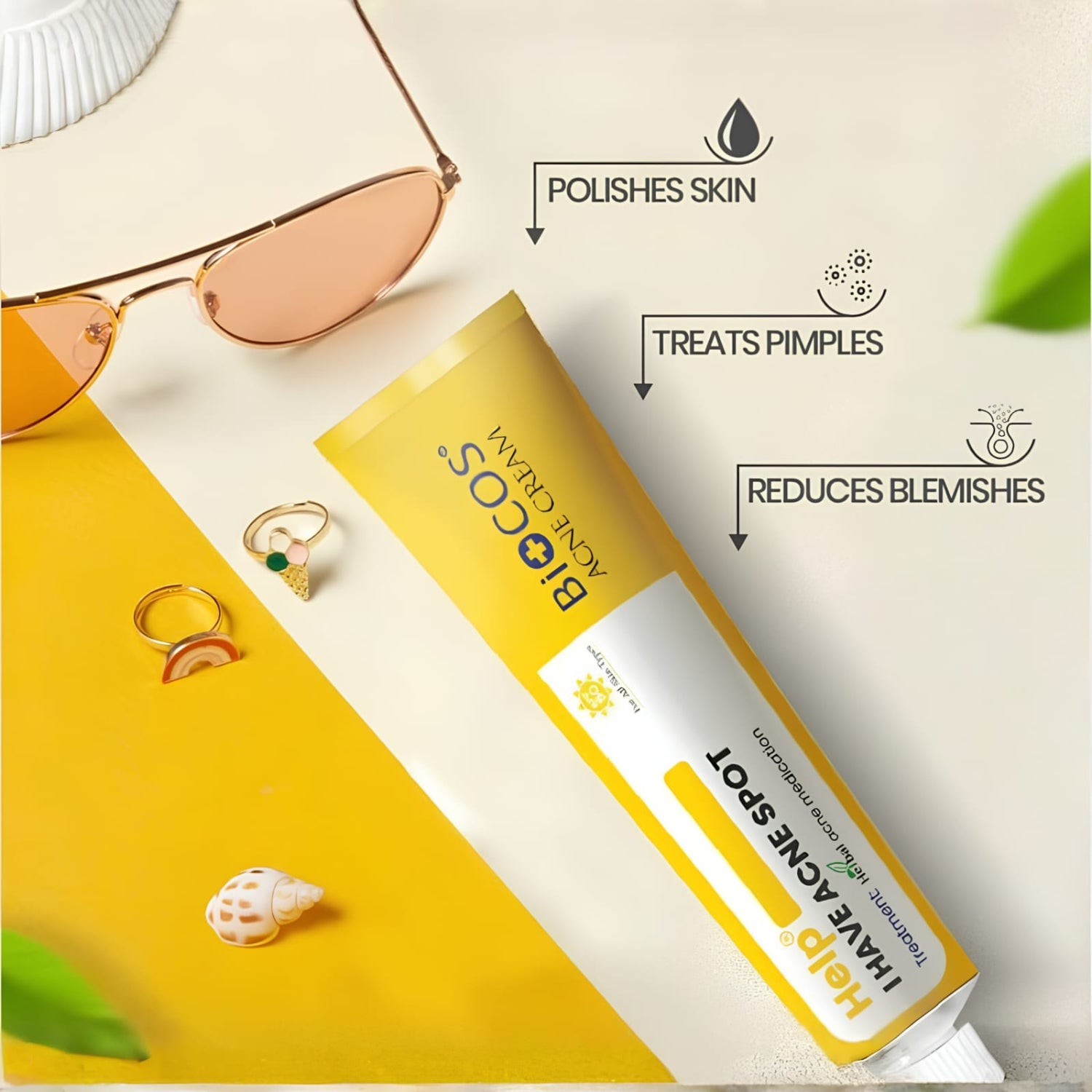A tube of BioCos Amla Chadi Ijawache Spot treatment is displayed on a styled flat-lay background with sunglasses, rings, and a seashell. Text overlays describe the product's benefits: polishes skin, treats pimples, and reduces blemishes.